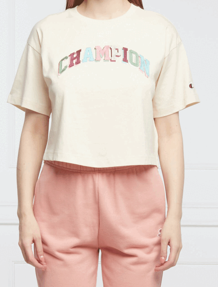 Damski crop top Champion z luźnym krojem i okrągłym dekoltem, zdobione centralnym logo marki, idealne do stworzenia modnego i komfortowego zestawu na każdą okazję.
